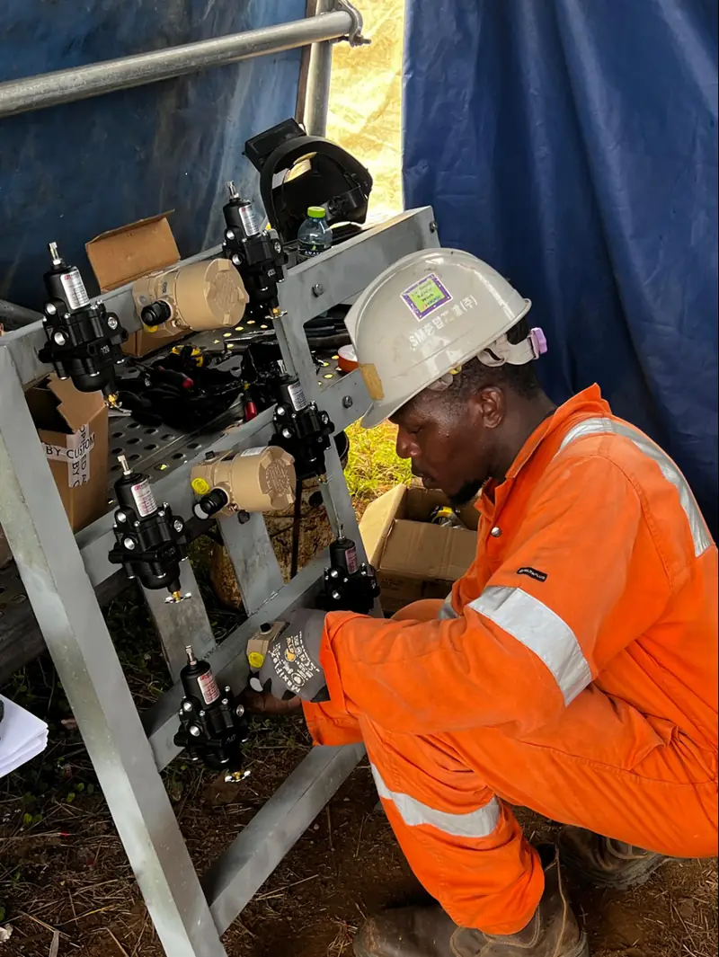 Engineer installing instrumentation on a skid
